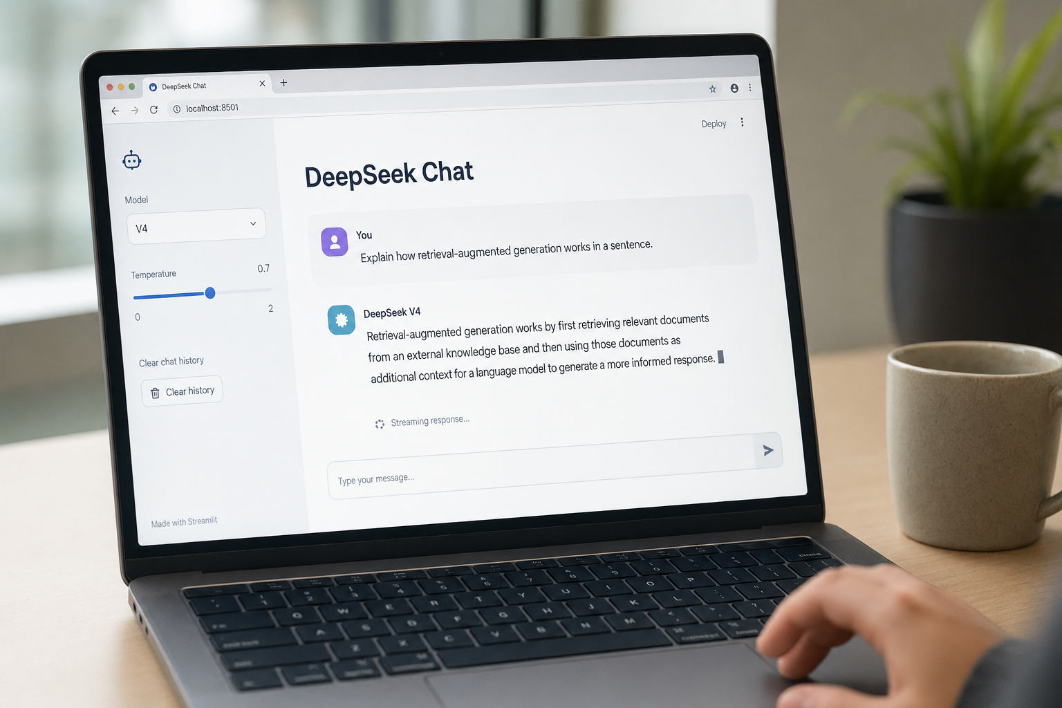 Laptop displaying a Streamlit chat app powered by DeepSeek V4 with sidebar controls and a streamed reply.